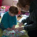 Helping Mommy wrap the presents Helping Mommy wrap the presents